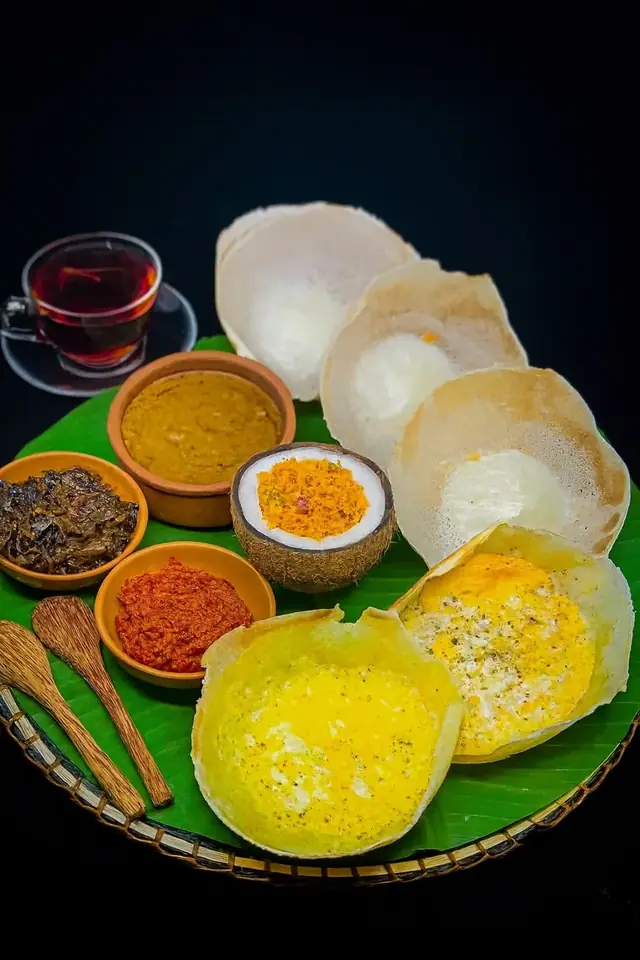 Plain and egg hoppers with sambols, curry and tea