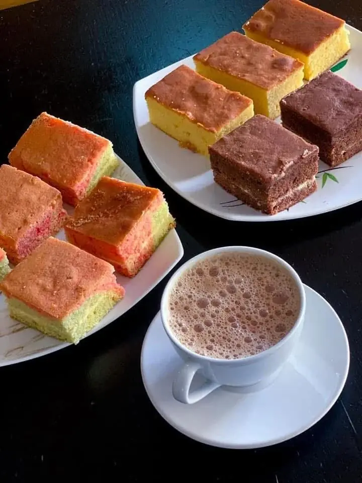 Ribbon cake, chocolate cake and a warm drink